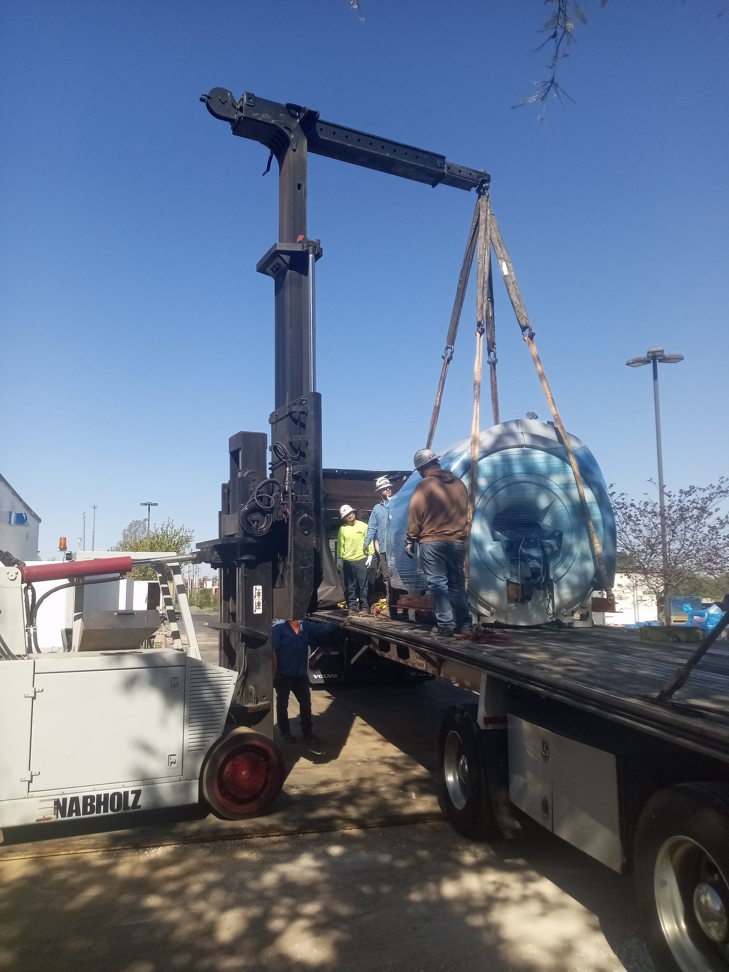 Rigging crew craning equipment to the building